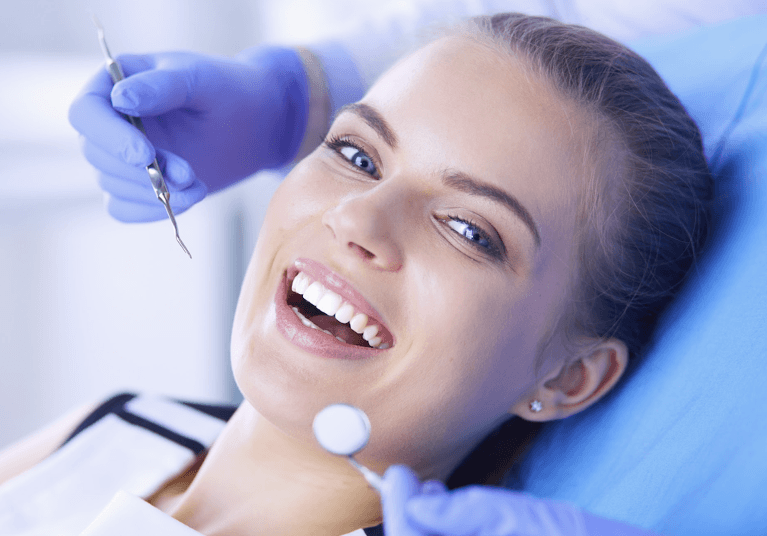 woman smiling in dentist exam chair | dentist in harrisonburg va